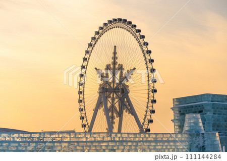 The giant snow ferris wheel in Harbin International Ice and Snow Sculpture Festival at Harbin, China. It is the world largest ice and snow festival. The giant snow ferris wheel in Harbin International Ice and Snow Sculpture Festival at Harbin, China. It is the world largest ice and snow festival. 111144284