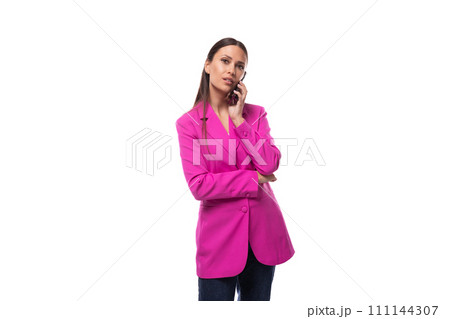 young well-groomed brunette successful boss woman dressed in a pink jacket speaks on the phone young well-groomed brunette successful boss woman dressed in a pink jacket speaks on the phone 111144307