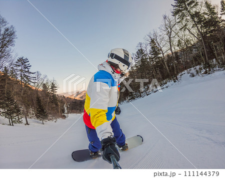 A daring man conquers snowy slopes with style, showcasing skill and thrill as he maneuvers on a snowboard, capturing the essence of winter adventure A daring man conquers snowy slopes with style, showcasing skill and thrill as he maneuvers on a snowboard, capturing the essence of winter adventure 111144379
