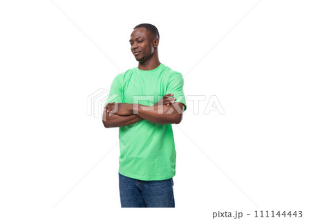 a handsome 30 year old african man dressed in a light green basic t-shirt has a strategy a handsome 30 year old african man dressed in a light green basic t-shirt has a strategy 111144443