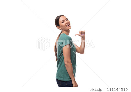 young beautiful brunette lady with a ponytail hairstyle is dressed in a green t-shirt and jeans on a 111144519