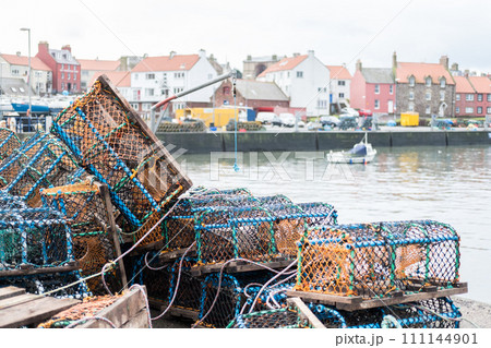Group of fist net traps with building on the background 111144901