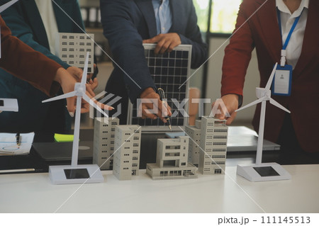 Close-up at tablet, Engineers pointing at tablet with their hands. To jointly design the use of renewable energy with wind and solar energy. Concept of using renewable energy. Close-up at tablet, Engineers pointing at tablet with their hands. To jointly design the use of renewable energy with wind and solar energy. Concept of using renewable energy. 111145513