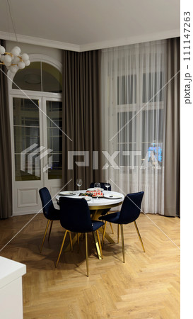 spacious living room with a small table for dinner spacious living room with a small table for dinner 111147263