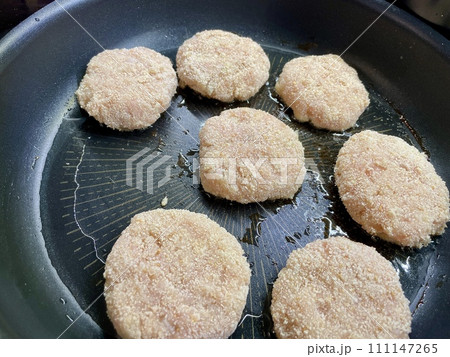 Delicious meat cutlets are being fried in a frying pan in the kitchen Delicious meat cutlets are being fried in a frying pan in the kitchen 111147265