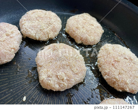 Delicious meat cutlets are being fried in a frying pan in the kitchen Delicious meat cutlets are being fried in a frying pan in the kitchen 111147267