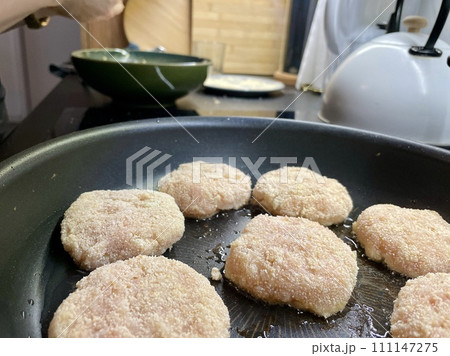 Delicious meat cutlets are being fried in a frying pan in the kitchen 111147275