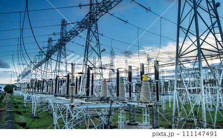 High voltage power transformer substation before russian bombed on Ukraine territory. High voltage tower with blue sky and sunset. High voltage power transformer substation before russian bombed on Ukraine territory. High voltage tower with blue sky and sunset. 111147491