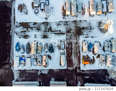 Drone view of camper, mobile home, and boat winter storage. 111147624