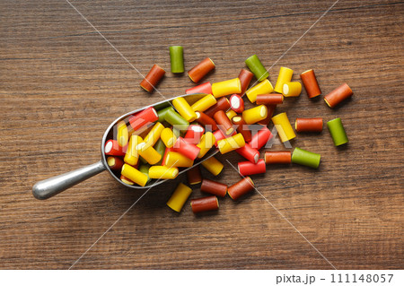 Colorful sweet jelly candies in scoop on wooden table. Top view. Colorful sweet jelly candies in scoop on wooden table. Top view. 111148057