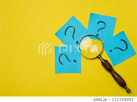 Drawn question marks on stickers and a magnifying glass, yellow background. Searching for truth and answering questions Drawn question marks on stickers and a magnifying glass, yellow background. Searching for truth and answering questions 111148092