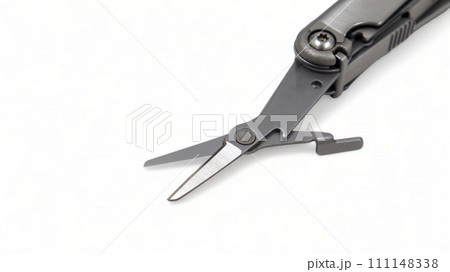 The scissors tool is pulled out of the multitool. Modern steel multitool with many tools isolated on white background. Compact and portable product. Pocket knife. EDC concept. Copy space 111148338