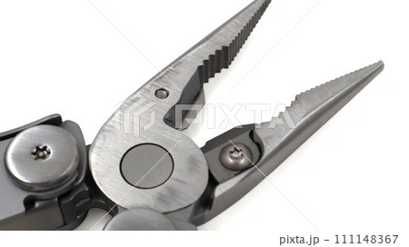 One modern gray iron open folding multifunctional knife on a white background. Multi-tool with advanced tools. Pliers close up. Compact and portable product. Pocket knife. EDC concept. Copy space 111148367