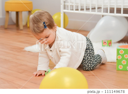 Girl playing with toys in the white children's room 111149678