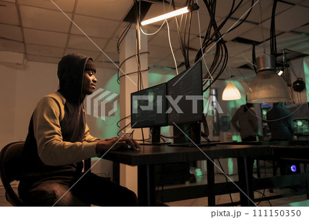 Cyberattack, hacker stealing government database information, data breach. Cybercrime, internet criminal hacking computer system, programming internet virus, coding malware at night time 111150350