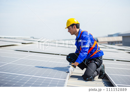 Technicians are installing and inspecting standards of solar panels on roof. 111152889
