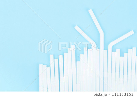 Group of plastic white drinking straw on blue background Group of plastic white drinking straw on blue background 111153153