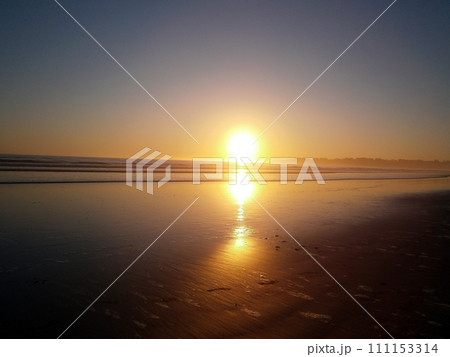 Epic sunset reflects on ocean and beach Epic sunset reflects on ocean and beach 111153314