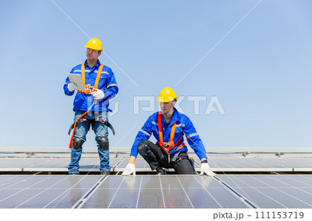 Technicians are installing and inspecting standards of solar panels on roof of an industrial. 111153719