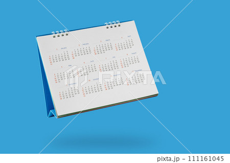 White paper desk calendar flipping page isolated on blue background White paper desk calendar flipping page isolated on blue background 111161045