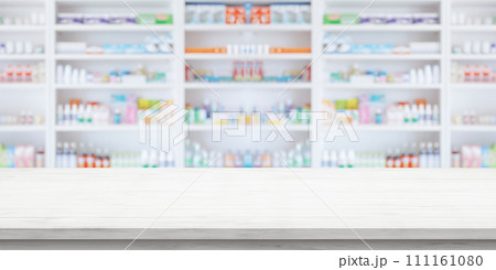 Empty white wood counter top with blur pharmacy drugstore shelves background 111161080