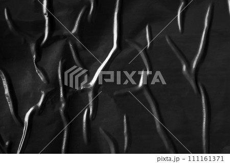 black crumpled and creased plastic poster texture background 111161371