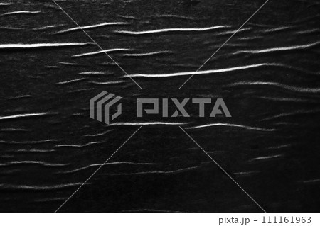 Black crumpled and creased paper poster texture background Black crumpled and creased paper poster texture background 111161963