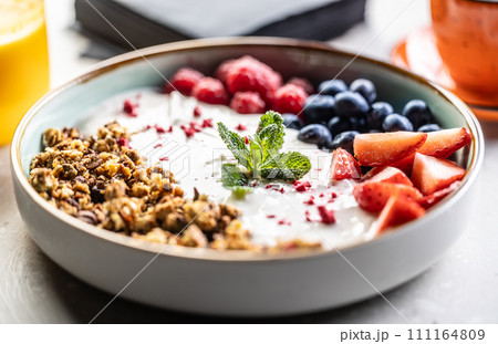A bowl full of berries, yogurt and cereal. Healthy breakfast concept 111164809