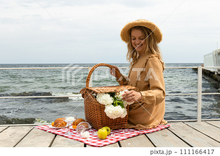 The concept of a picnic by the sea, with flowers. 111166417