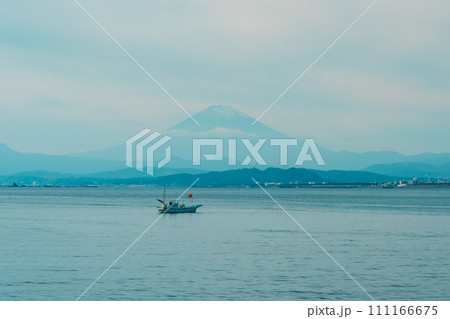 Scenery Kamakura Yuigahama Beach with Kamakura city and Fujisan mountain. Mount Fuji behind Enoshima island at Kamakura, Kanagawa, Japan. Landmark for tourist attraction near tokyo 111166675