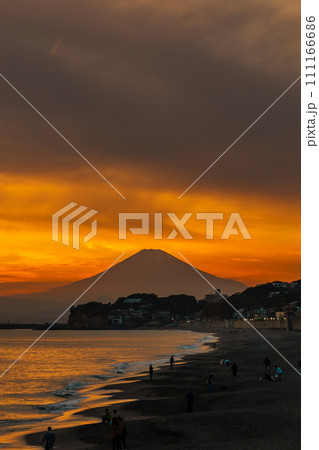 Scenery Kamakura Yuigahama Beach with Kamakura city and Fujisan mountain. Twilight silhouette Mount Fuji behind Enoshima island at Kamakura, Kanagawa, Japan. Landmark for tourist attraction near tokyo 111166686