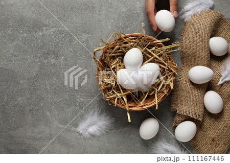 Eggs in a wicker basket, on a gray background. Eggs in a wicker basket, on a gray background. 111167446