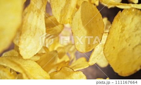 Flying Fried Potato Chips Levitating in the Air. Concept of Flying Junk Food. Selective Focus. 111167664