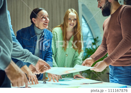 Hard-working creative employees working together on project, developing profitable strategy for startup launch, checking analytics and metrics 111167876