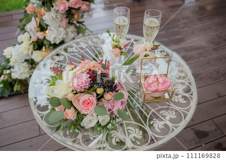 champagne and rings on an arch table for ceremony champagne and rings on an arch table for ceremony 111169828