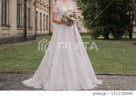 bride with a bouquet of flowers in the park 111170046