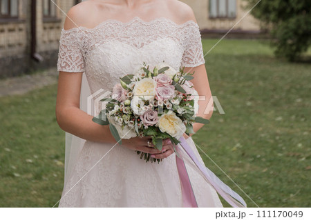 bride with a bouquet of flowers in the park 111170049