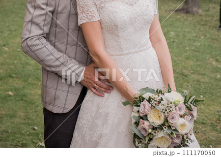 bride and groom in summer park together 111170050