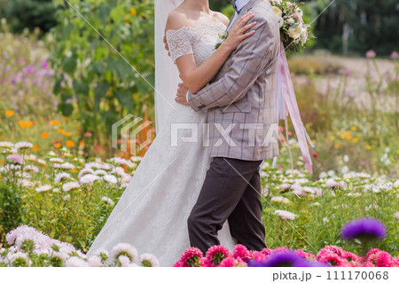 bride and groom in a park with flowers bride and groom in a park with flowers 111170068