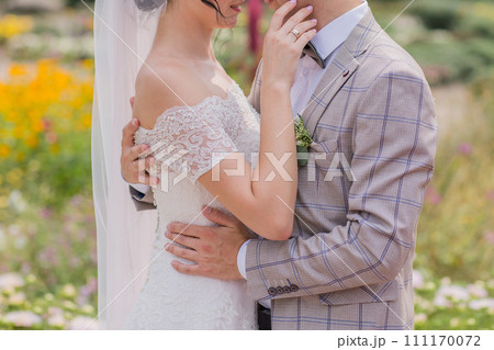 bride and groom in a park with flowers bride and groom in a park with flowers 111170072