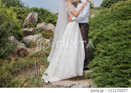 bride and groom in summer park together 111170077