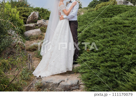 bride and groom in summer park together 111170079