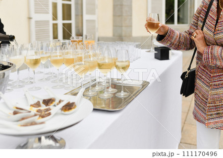 A wedding guest takes champagne and waiters pouring champagne 111170496