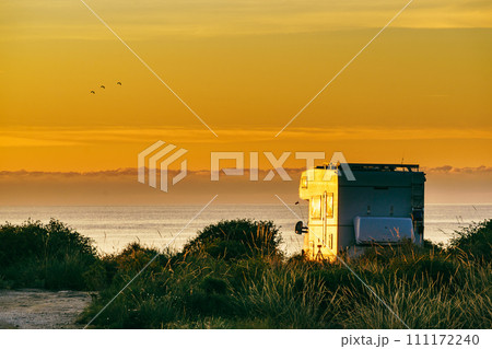 Caravan on nature in the morning at sunrise 111172240