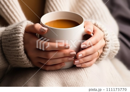 A close up shot of a girl's hands holding a mug 111173770