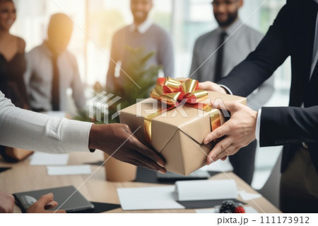 Close up view of hands Giving a business gift in an office 111173912