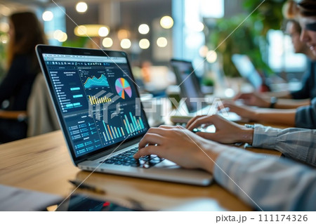Person using a laptop with financial data with graphs and charts on a laptop computer at workplace Person using a laptop with financial data with graphs and charts on a laptop computer at workplace 111174326