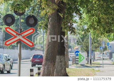 traffic light at a railway crossing on the road 111175379