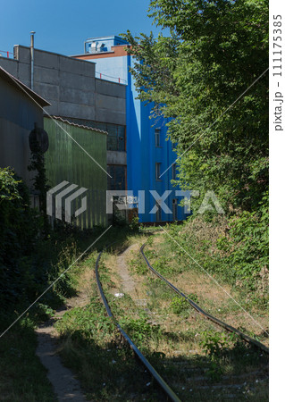 train rails near an industrial building train rails near an industrial building 111175385