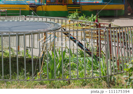 empty trampoline in children park 111175394